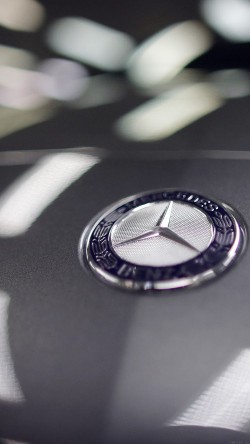 A company logo is seen on a Mercedes-Benz A-class car displayed in a dealership of German car manufacturer Daimler in Paris